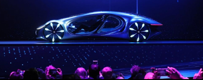 carros do futuro expostos em feira de tecnologia automobilistica, em cima de um palco, com visitantes fotografando
