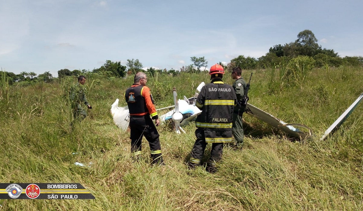 Agentes dos bombeiros ao lado de aeronave de pequeno porte que caiu em Taubaté