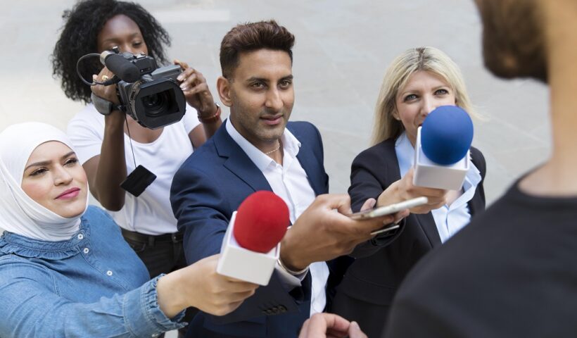 Imagem de repórteres que seriam europeus, entrevistando uma pessoa vista de costas. Matéria fala sobre importância de se ter um segundo idioma