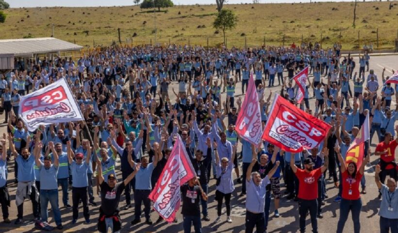 Tranalhadores da GM levantam os braços para aprovar fim da greve. Termina a greve na GM após acordo para suspender 1,2 mil demissões