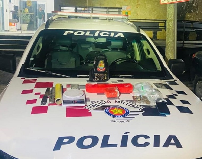 drogas expostas em cima de capô de viatura da PM. 