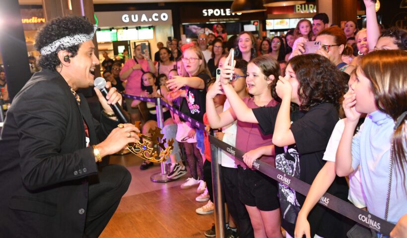 Sósia de Bruno Mars cantando al lado de crianças